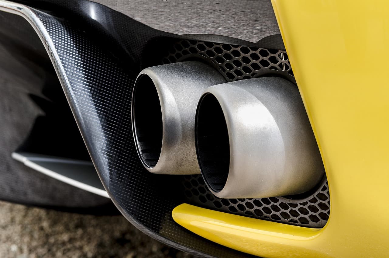 Twin exhaust tips set into a sports car's rear diffuser