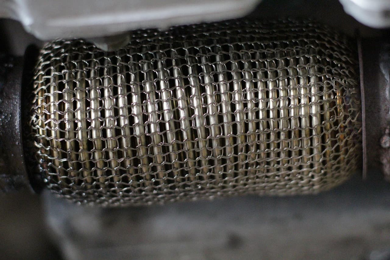 A braided flexi section in an exhaust, seen from under the car